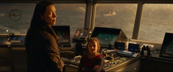 Movie still from “Godzilla vs. Kong” (2021), directed by Adam Wingard – Two people standing next to each other in front of a computer monitor; Medium shot, Over the shoulder angle