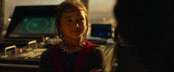 Movie still from “Godzilla vs. Kong” (2021), directed by Adam Wingard – A young girl wearing a necklace in front of a computer monitor; Close Up shot, Over the shoulder angle