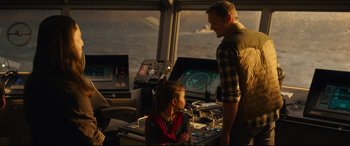 Movie still from “Godzilla vs. Kong” (2021), directed by Adam Wingard – A man standing next to a little girl in front of a computer; Medium shot, Over the shoulder angle