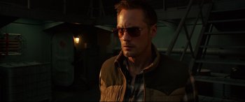 Movie still from “Godzilla vs. Kong” (2021), directed by Adam Wingard – A person wearing sunglasses and a jacket; Close Up shot, Low angle