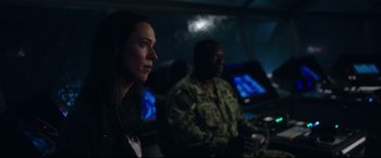 Movie still from “Godzilla vs. Kong” (2021), directed by Adam Wingard – A woman sitting next to a man in uniform; Medium shot, Over the shoulder angle
