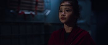 Movie still from “Godzilla vs. Kong” (2021), directed by Adam Wingard – A young girl in a red jacket looking up; Close Up shot, Over the shoulder angle