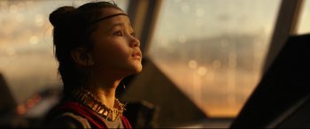Movie still from “Godzilla vs. Kong” (2021), directed by Adam Wingard – A little girl looking up at the sky with her eyes wide open; Close Up shot, Low angle