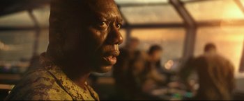 Movie still from “Godzilla vs. Kong” (2021), directed by Adam Wingard – A man's face in a military uniform; Close Up shot, Over the shoulder angle