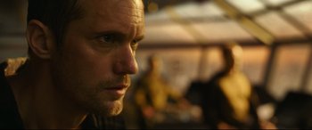 Movie still from “Godzilla vs. Kong” (2021), directed by Adam Wingard – A man's face in a room; Close Up shot, Over the shoulder angle