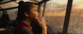 Movie still from “Godzilla vs. Kong” (2021), directed by Adam Wingard – A young girl sitting in a car looking out the window; Close Up shot, Over the shoulder angle