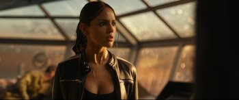 Movie still from “Godzilla vs. Kong” (2021), directed by Adam Wingard – A beautiful woman wearing a leather jacket and looking to her left; Close Up shot, Over the shoulder angle