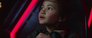 Movie still from “Godzilla vs. Kong” (2021), directed by Adam Wingard – A little girl looking up into the air; Close Up shot, Over the shoulder angle