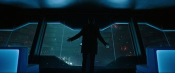 Movie still from “Godzilla vs. Kong” (2021), directed by Adam Wingard – A man standing in front of a window in a dark room; Wide shot, Low angle