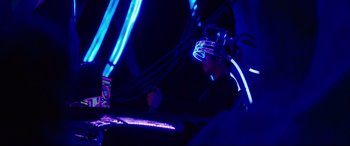 Movie still from “Godzilla vs. Kong” (2021), directed by Adam Wingard – A man in a neon helmet sitting in a chair; Medium shot, Over the shoulder angle