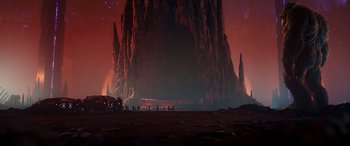 Movie still from “Godzilla vs. Kong” (2021), directed by Adam Wingard – A group of people standing in front of a large rock formation; Extreme Wide shot, Low angle