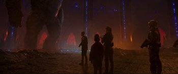 Movie still from “Godzilla vs. Kong” (2021), directed by Adam Wingard – A group of people standing in a dark room; Extreme Wide shot, Over the shoulder angle
