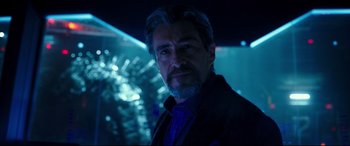 Movie still from “Godzilla vs. Kong” (2021), directed by Adam Wingard – A person wearing a suit and tie; Close Up shot, Over the shoulder angle