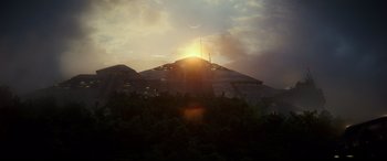 Movie still from “Godzilla vs. Kong” (2021), directed by Adam Wingard – The sun is setting over a building in the forest; Extreme Wide shot, Low angle