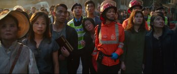 Movie still from “Godzilla vs. Kong” (2021), directed by Adam Wingard – A group of people standing next to each other on a street; Medium shot, Over the shoulder angle
