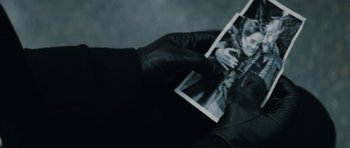 Movie still from “The Broken” (2008), directed by Sean Ellis – A person is holding a picture of a man; Extreme Close Up shot, High angle