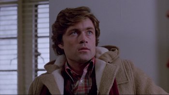 Movie still from “The Brood” (1979), directed by David Cronenberg – A person wearing a jacket; Close Up shot, Low angle