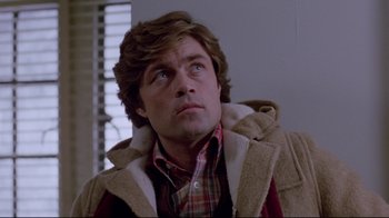 Movie still from “The Brood” (1979), directed by David Cronenberg – A person wearing a jacket; Close Up shot, Low angle