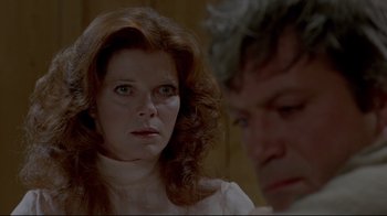 Movie still from “The Brood” (1979), directed by David Cronenberg – A person wearing a white shirt; Close Up shot, Over the shoulder angle