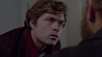 Movie still from “The Brood” (1979), directed by David Cronenberg – A person wearing a red scarf; Close Up shot, Over the shoulder angle