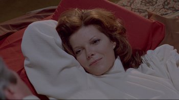 Movie still from “The Brood” (1979), directed by David Cronenberg – A person laying on a chair; Close Up shot, High angle