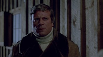 Movie still from “The Brood” (1979), directed by David Cronenberg – An older man wearing a sweater and a jacket; Close Up shot, Low angle