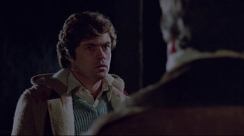 Movie still from “The Brood” (1979), directed by David Cronenberg – A man looking at himself in the mirror in front of a mirror; Close Up shot, Over the shoulder angle