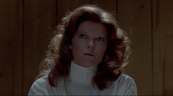 Movie still from “The Brood” (1979), directed by David Cronenberg – A person wearing a white shirt; Close Up shot, Low angle