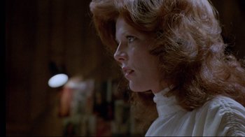 Movie still from “The Brood” (1979), directed by David Cronenberg – A person with long hair; Close Up shot, Over the shoulder angle