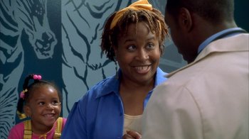 Movie still from “The Brothers” (2001), directed by Gary Hardwick – A woman smiles while standing next to two other people; Close Up shot, Over the shoulder angle
