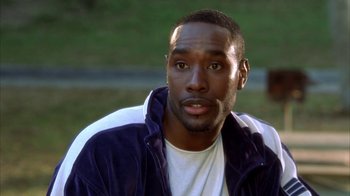 Movie still from “The Brothers” (2001), directed by Gary Hardwick – A person sitting on a bench; Close Up shot, High angle