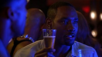 Movie still from “The Brothers” (2001), directed by Gary Hardwick – A person holding a drink in a glass; Close Up shot, Over the shoulder angle