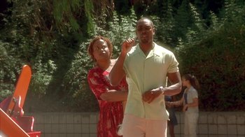 Movie still from “The Brothers” (2001), directed by Gary Hardwick – A man and a woman standing next to each other outside; Medium shot, Over the shoulder angle
