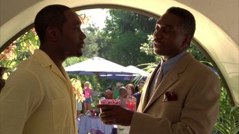 Movie still from “The Brothers” (2001), directed by Gary Hardwick – Two men are talking in front of an outdoor party; Medium shot, Over the shoulder angle
