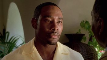 Movie still from “The Brothers” (2001), directed by Gary Hardwick – A person wearing a white shirt; Close Up shot, High angle