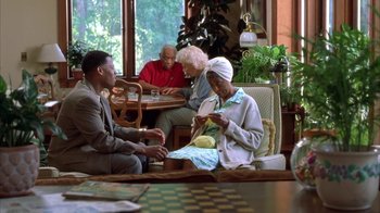 Movie still from “The Brothers” (2001), directed by Gary Hardwick – A group of people sitting around a table; Medium shot, High angle