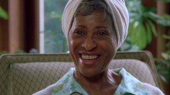 Movie still from “The Brothers” (2001), directed by Gary Hardwick – An older woman wearing a head scarf smiling for the camera; Close Up shot, Low angle