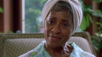 Movie still from “The Brothers” (2001), directed by Gary Hardwick – An older woman wearing a head towel on top of her head; Close Up shot, Low angle