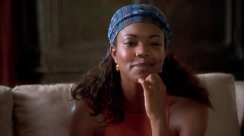 Movie still from “The Brothers” (2001), directed by Gary Hardwick – A woman sitting on top of a couch with her hand on her chin; Close Up shot, Over the shoulder angle