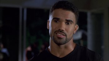 Movie still from “The Brothers” (2001), directed by Gary Hardwick – A person wearing a black t - shirt; Close Up shot, High angle