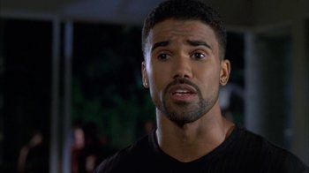 Movie still from “The Brothers” (2001), directed by Gary Hardwick – A person wearing a black t - shirt; Close Up shot, High angle