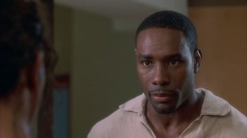 Movie still from “The Brothers” (2001), directed by Gary Hardwick – A person wearing a white shirt; Close Up shot, Over the shoulder angle