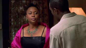 Movie still from “The Brothers” (2001), directed by Gary Hardwick – A woman in a black dress is talking to a man in a pink jacket; Close Up shot, Over the shoulder angle