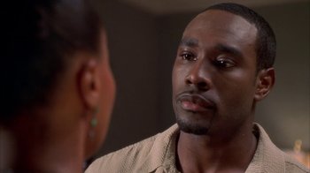 Movie still from “The Brothers” (2001), directed by Gary Hardwick – A man and a woman looking at one another in the mirror; Close Up shot, Over the shoulder angle