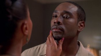 Movie still from “The Brothers” (2001), directed by Gary Hardwick – A woman touching a mans face in front of a bathroom mirror; Close Up shot, Over the shoulder angle