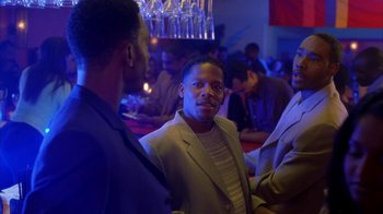 Movie still from “The Brothers” (2001), directed by Gary Hardwick – Two men are talking to each other at a party; Medium shot, Over the shoulder angle