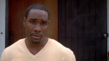 Movie still from “The Brothers” (2001), directed by Gary Hardwick – A person wearing a white t - shirt; Close Up shot, High angle