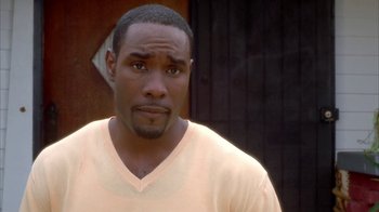 Movie still from “The Brothers” (2001), directed by Gary Hardwick – A person wearing a white t - shirt; Close Up shot, High angle