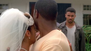 Movie still from “The Brothers” (2001), directed by Gary Hardwick – A man and a woman kissing in front of another man; Close Up shot, Over the shoulder angle