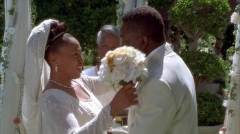 Movie still from “The Brothers” (2001), directed by Gary Hardwick – A man and a woman holding a bouquet of flowers; Close Up shot, Over the shoulder angle